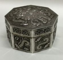 A 19th Century octagonal Chinese silver box embossed with dragons and flowers.