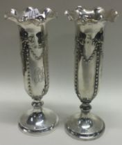 A pair of silver vases with swag decoration. London 1906.