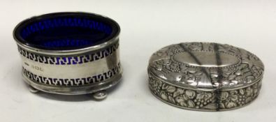 An oval silver salt together with a pill box with chased decoration.