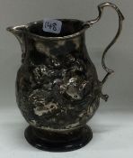 An 18th Century chased silver pitcher cream jug. Circa 1760.