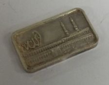 A fine half ounce silver ingot with chased scene of a mosque. Signed.