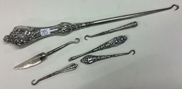 A good collection of silver mounted button hooks.