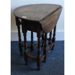 A good oak drop leaf table on turned supports.