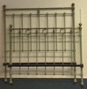 A green painted metal bed frame.