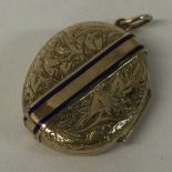 A Victorian gold and enamelled locket with buckle decoration.