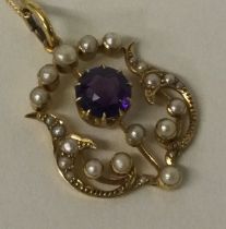 A 15 carat gold amethyst and pearl pendant on fine link chain.