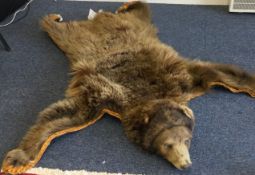 A wall hanging of a brown bear.