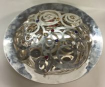A large contemporary silver bowl with pierced cover and set with gemstones.