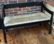 A stylish Arts and Crafts bench with cane seat.