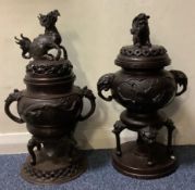 A good matched pair of bronze censers on stands with lift off covers decorated with animals.
