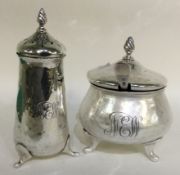 A heavy silver two piece cruet set of stylised form.