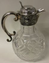 A Victorian silver and glass claret jug.