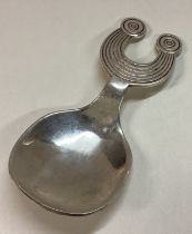 An Irish silver contemporary caddy spoon of unusual shape.