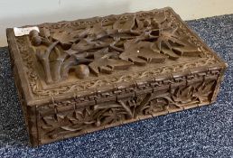 An Oriental carved box with hinged lid. Est. £30 -