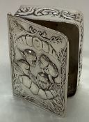 A novelty silver hinged box in the form of a book.