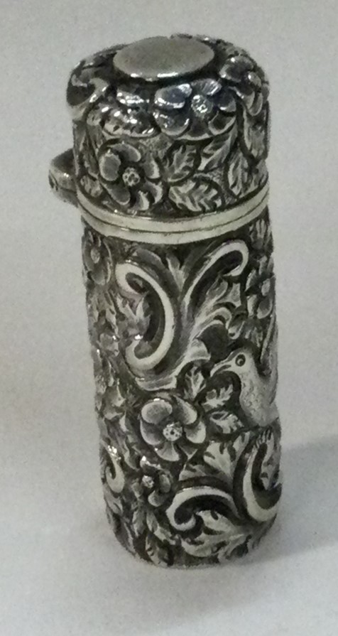 SAMPSON MORDAN AND CO: A Victorian silver chased scent bottle embossed with birds.