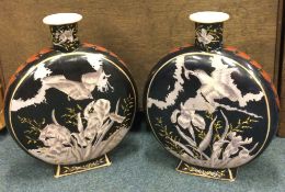 A pair of large Chinese vases decorated with birds on dark background.