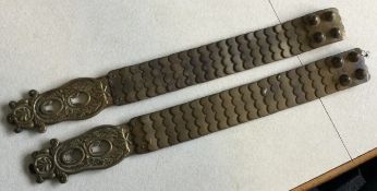 A pair of British Dragoons Household Cavalry brass and leather breast plate shoulder straps.
