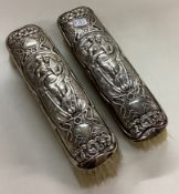 A novelty silver clothes brush chased with women.