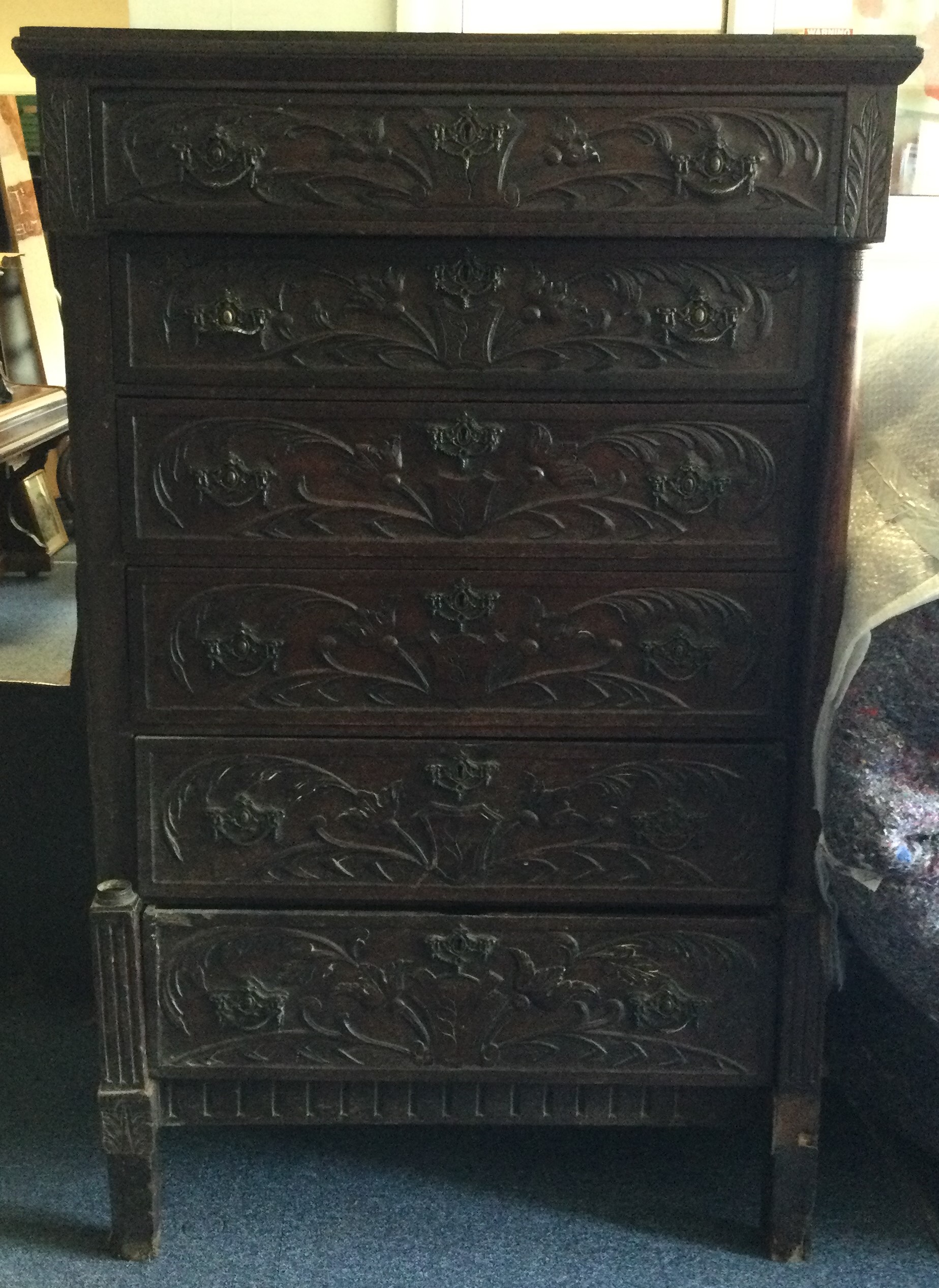 An Antique oak carved six drawer chest.