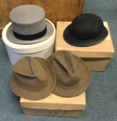 Four boxed top hats.