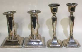 A pair of silver mounted candlesticks of tapering form.