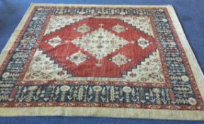 A large square rug in bright colours with central medallion.