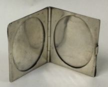 An engine turned Sterling silver double photo frame.