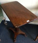 A Victorian mahogany single pedestal table on scroll feet.