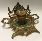 An attractive brass mounted ink stand with scroll decocation.