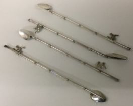 A fine set of four Sterling silver cocktail sticks.