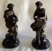 A good pair of bronze ladies in seated position mounted on circular marble bases.
