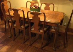 A walnut Queen Anne style table together with matching chairs.