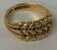 An 18 carat gold keeper ring.