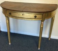 An attractive gilt single drawer hall table on turned tapering supports.