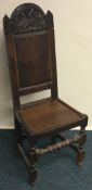 An Antique oak hall chair with carved decoration.