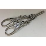 A fine pair of pierced silver grape scissors chased with flowers.