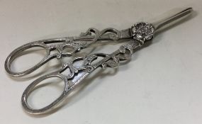 A fine pair of pierced silver grape scissors chased with flowers.