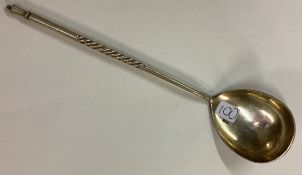 An engraved Russian silver spoon with spiral handle.