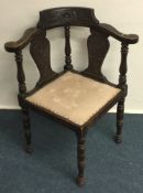 A good oak carved corner chair on turned supports.