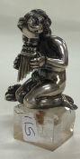 A 19th Century novelty silver figure of musical cherub on square base.