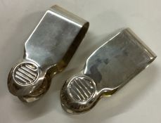 A pair of silver money clips.