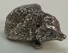A silver plated figure of a hedgehog.