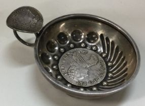 A heavy 19th Century silver wine taster with an 18th Century 1786 coin to centre and coin to handle.