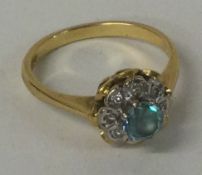 A zircon and diamond cluster ring in 18 carat gold setting.