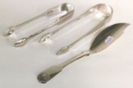 EXETER: A fiddle pattern silver butter knife together with two pairs of silver tongs.