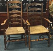 A pair of large oak carver chairs.