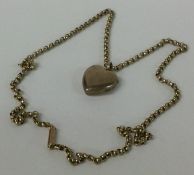 A 9 carat heart shaped locket on fine link chain.
