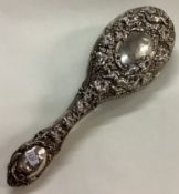 A novelty silver clothes brush with vine pattern.
