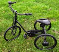 A small metal child's tricycle.